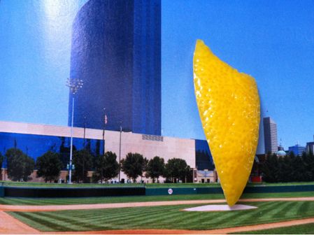  A piece of lemon peel on a magazine page, where the peel looks like a creative public sculpture.