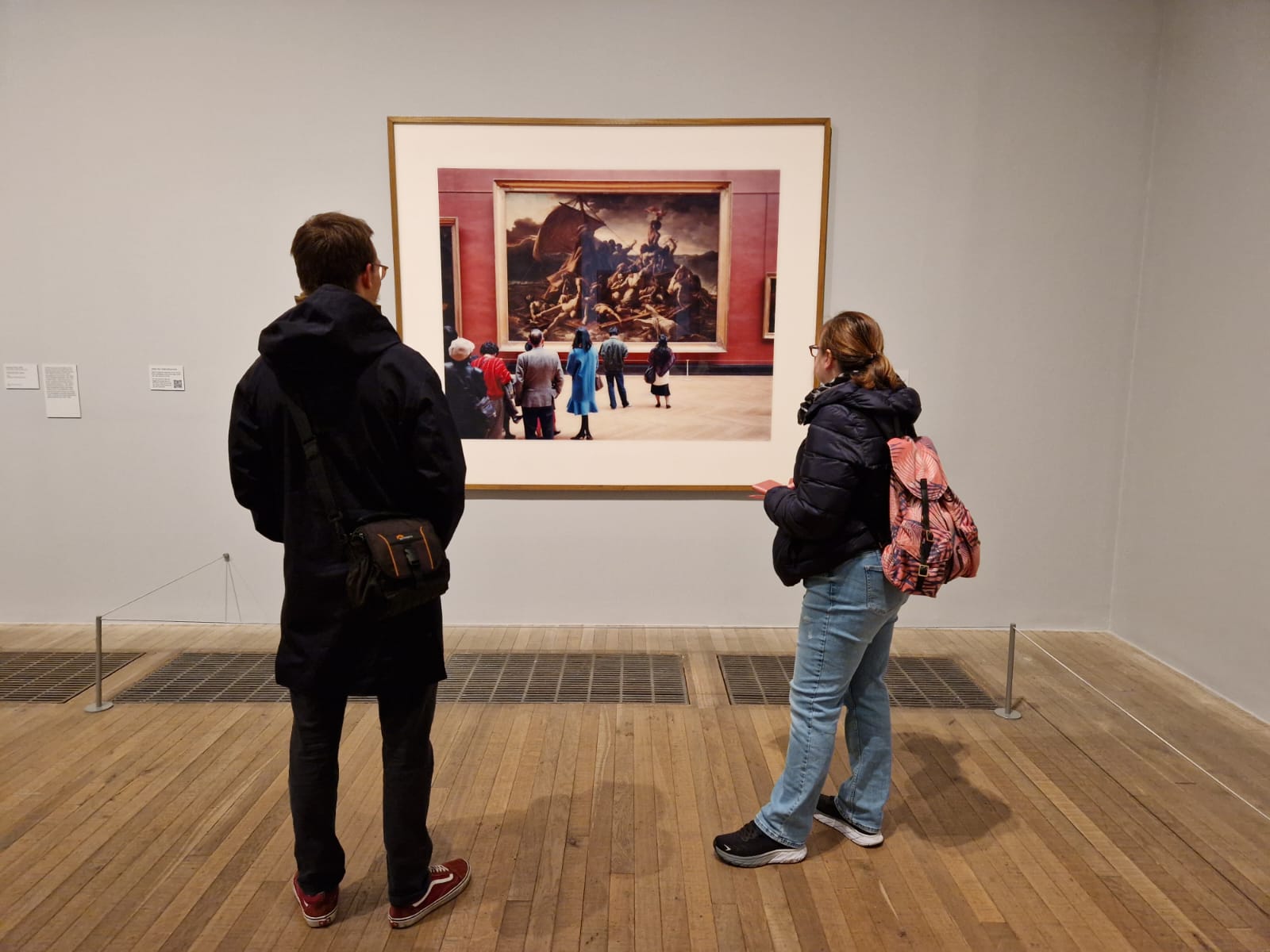 People in a museum looking at a piece of art in which there are people in a museum looking at a piece of art!