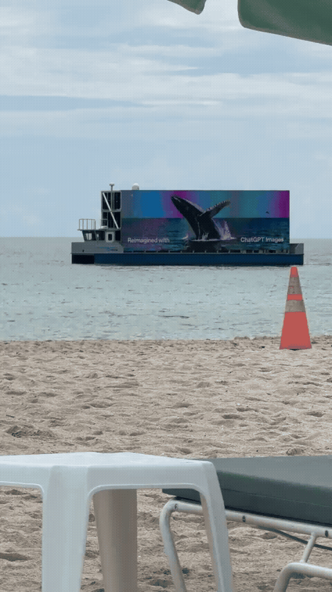 Ship showing an AI generated image of a whale jumping out of the water.