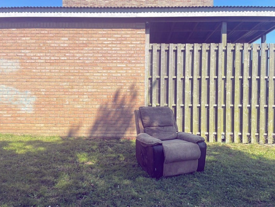 Abandoned sofa lying on the grass.